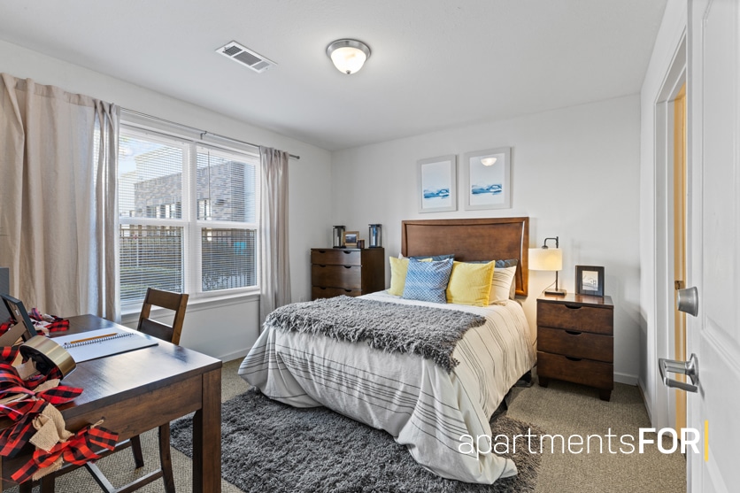 a bedroom with a bed and a desk