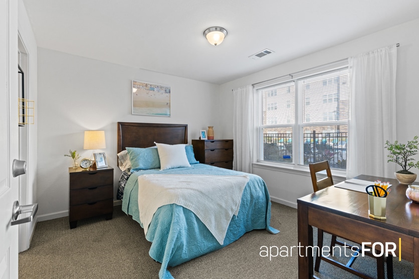 a bedroom with a desk and a bed