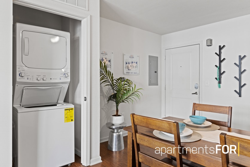 a room with a washing machine and a table