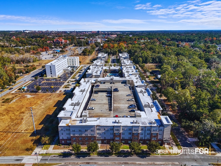 a aerial view of a large building with trees and a parking lot