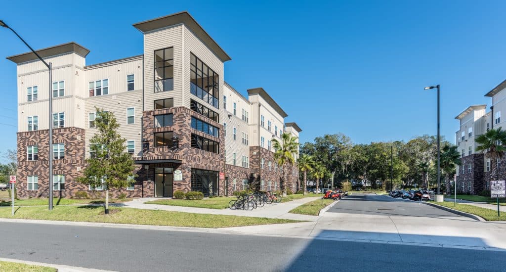 a building with trees and a parking lot