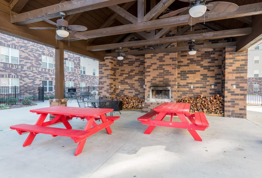 a red picnic tables under a covered patio