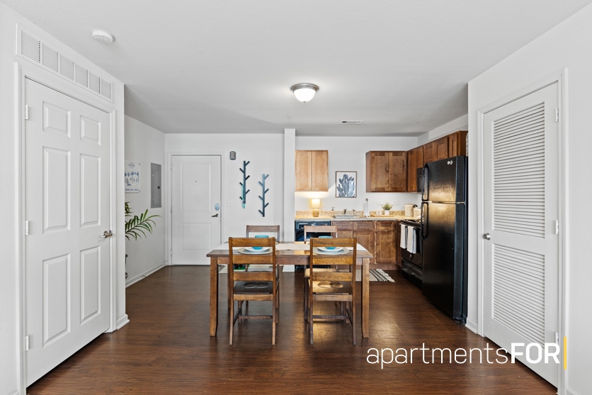 a kitchen and dining room with a table and chairs