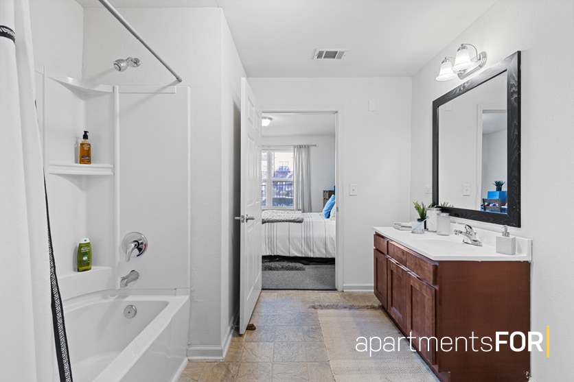 a bathroom with a bathtub and sink
